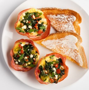 Spinach and Canadian bacon egg muffins served with a side of toast