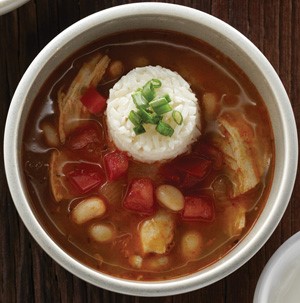 Soup with white beans, diced tomatoes, white rice, and chopped green onions