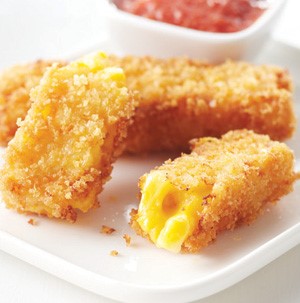 Breaded squares of macaroni and cheese with a side of red sauce for dipping