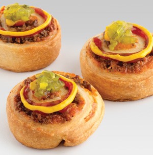 Cheeseburger roll-ups garnished wtih ketchup, mustard and relish