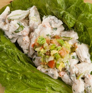 Crab salad topped with fresh guacamole and served on romaine lettuce