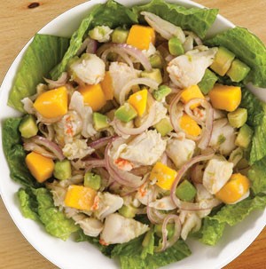 Bowl of crab salad drizzled in citrus dressing