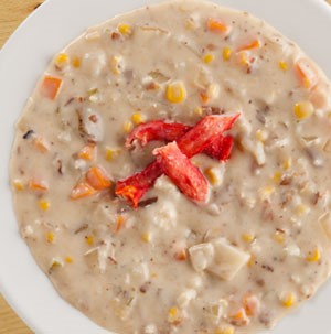 Bowl of corn chowder topped with crab meat mixture