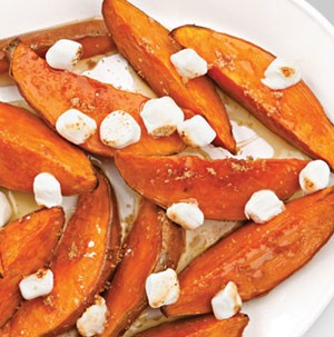 Thick sweet potato wedges topped with toasted mini marshmallows and drizzled with melted butter and brown sugar