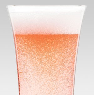 Carbonated pink drink in a clear glass