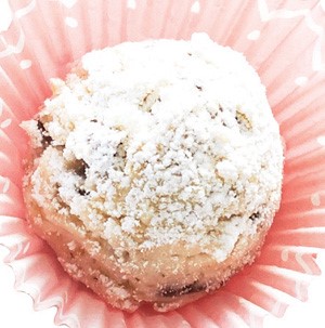 Snowball cookies in a pink cupcake liner dusted with powdered sugar