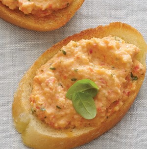 Bell pepper bruschetta mixture spread over toasted baguette