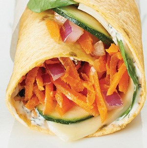 Shredded carrots, sliced, cheese, red onion, and cucumber wrapped in a tortilla