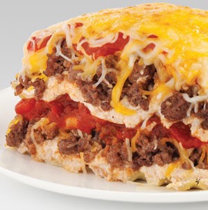 Layered lasagna filled with ground meat, tomatoes, and cheese