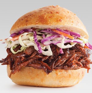 BBQ beef and coleslaw sandwiched between a bun