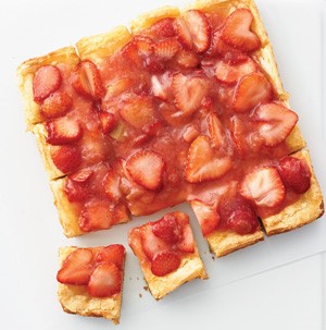 Yellow cake topped with rhubarb and strawberry sauce