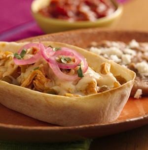 Flour tortilla boats filled with shredded barbecue chicken and melted cheese with red onions
