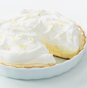 Pie plate filled with ice cream and topped with whipped cream and lemon zest