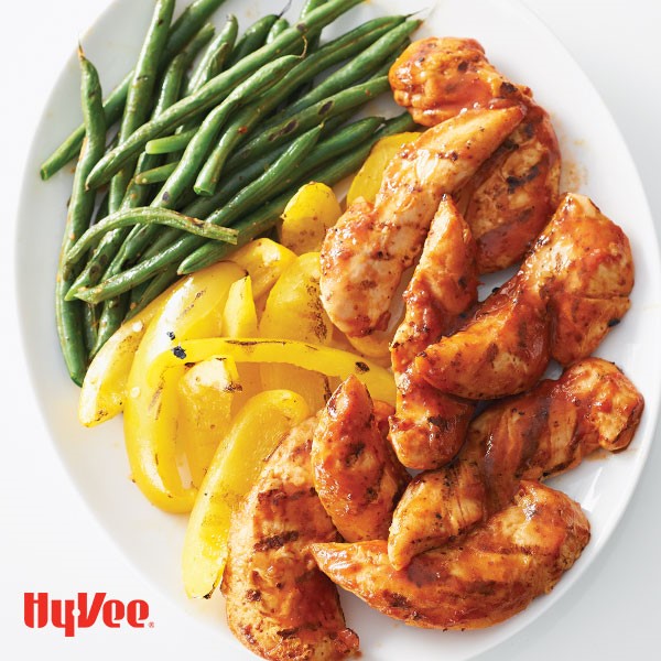 Plate of chipotle-orange chicken served with vegetable strips 