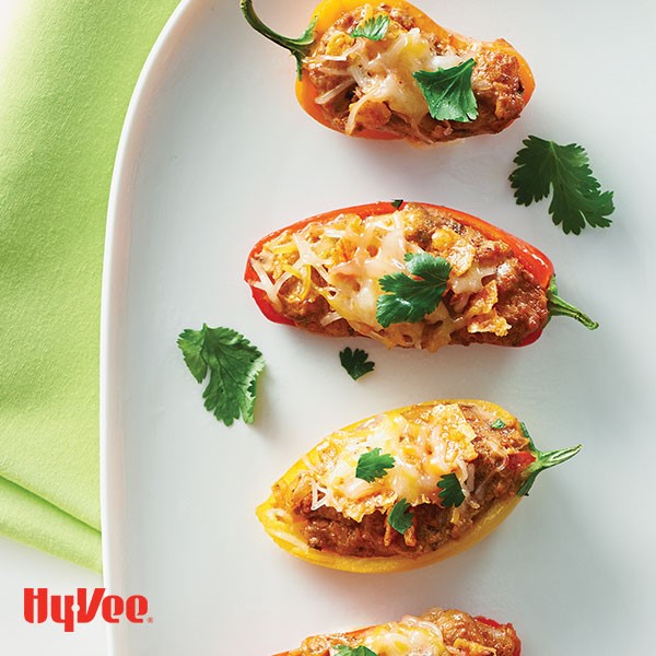 Platter of chorizo-nacho pepper poppers garnished with cilantro