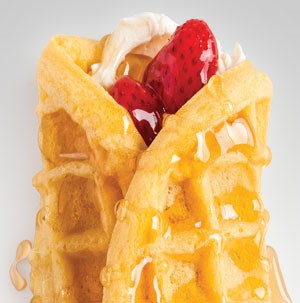 Cream cheese and strawberries wrapped in a waffle and drizzled with honey