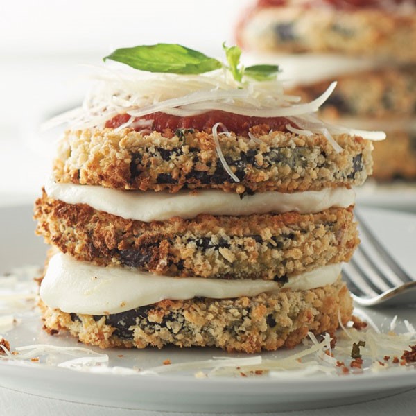 Caprese-style eggplant stacks topped with pasta sauce, shredded mozzarella and basil