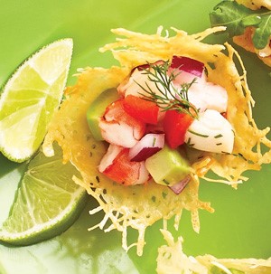 Parmesan crisp topped with ceviche served with lime wedges