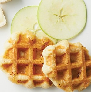 Waffle-shaped crescent rolls next to apple and brie slices