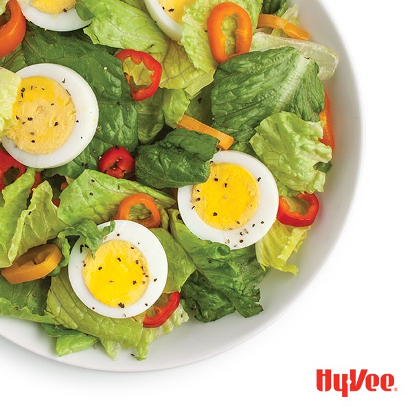 Plate of cobb salad with sweet peppers and hard boiled egg slices