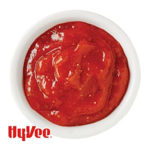 Spicy ketchup in a small white bowl