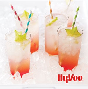 Four glasses of cachaca coolers garnished with starfruit and colored straws