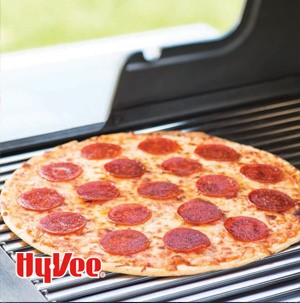 Frozen pepperoni pizza on a grill