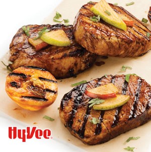 Plate of grilled pork chops garnished with pear slices