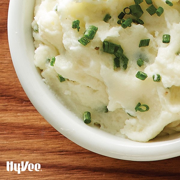 Bowl of asiago whipped potatoes topped with chives