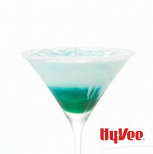 Blue and white drink in martini glass