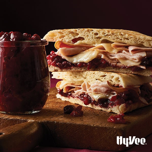 Artisan bread topped with cranberry sauce, cheese, and sliced turkey