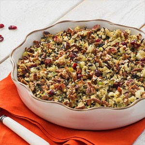 Wild rice and quinoa in a circular serving platter on orange napkin