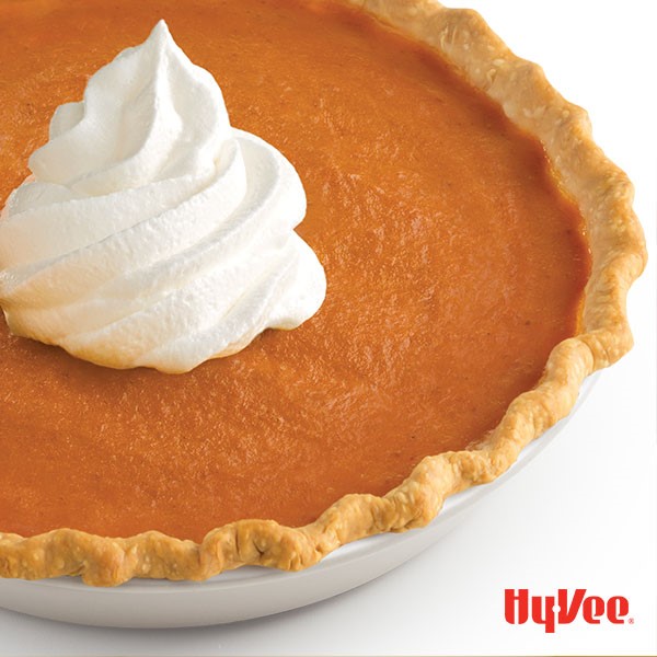 Sweet potato pumpkin pie served with a dollop of whipped topping