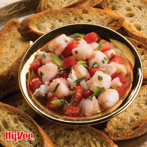 Side of seafood bruschetta mixture served alongside toasted baguette slices