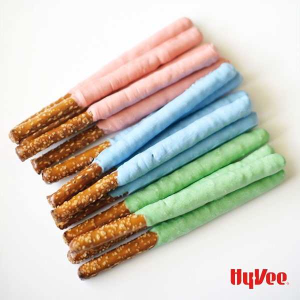 Pretzel sticks dipped in pink, blue, and green chocoalte