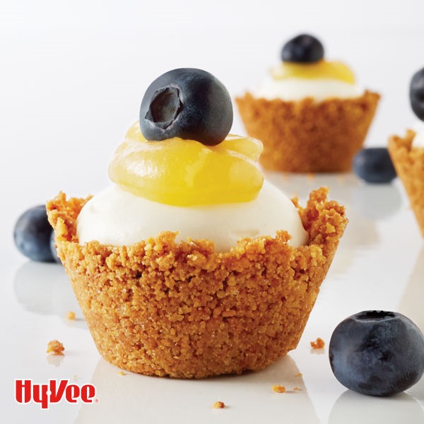 Cheesecake bites garnished with lemon curd and blueberries