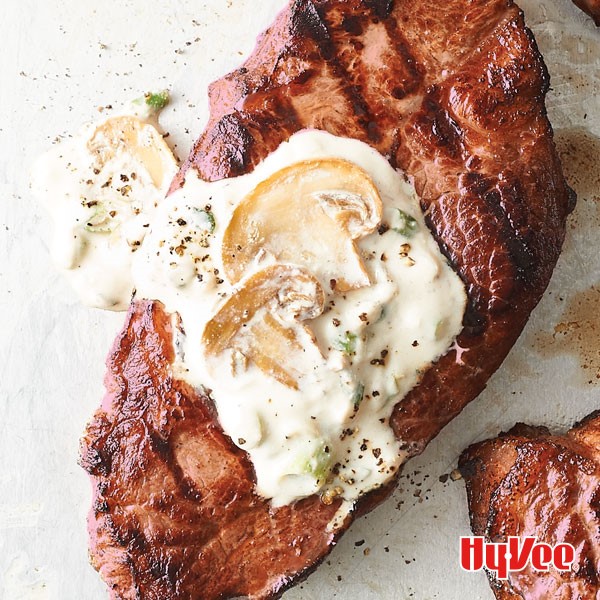 Grilled steak with a dollop of creamy mushroom sauce