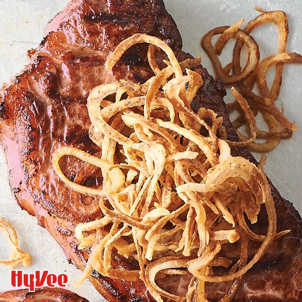 Grilled steaks topped with crispy shallots
