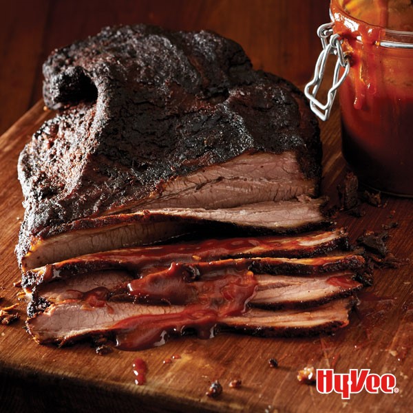Chef Mark's KC smoked brisket partially sliced on a wooden board