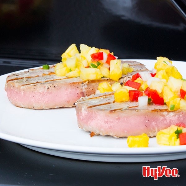 Plate of seared tuna steaks topped with pineapple-peach salsa