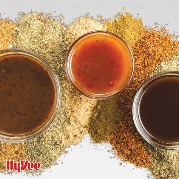 3 dipping sauces atop various ground spices