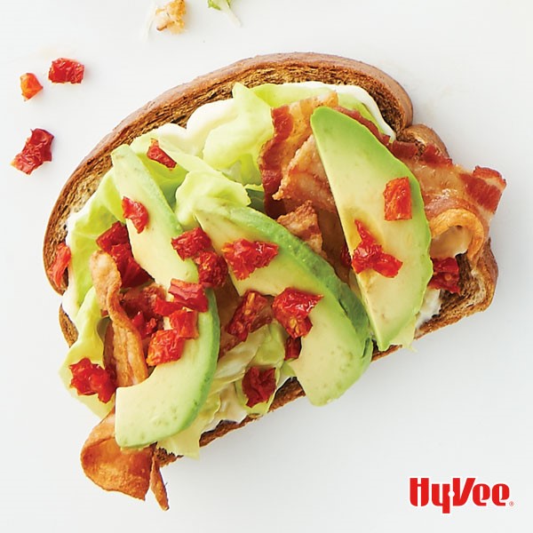 Marble rye topped with mayo, lettuce, bacon, avocado and tomatoes