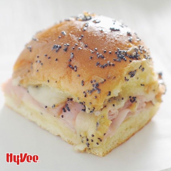 Hy-Waiian bun topped with poppy seeds and filled with ham and cheese