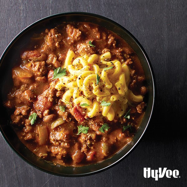 Chili with macaroni noodles and parsley 