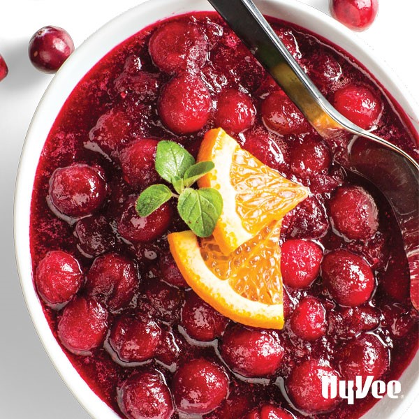 Bowl of cranberries garnished with orange slices