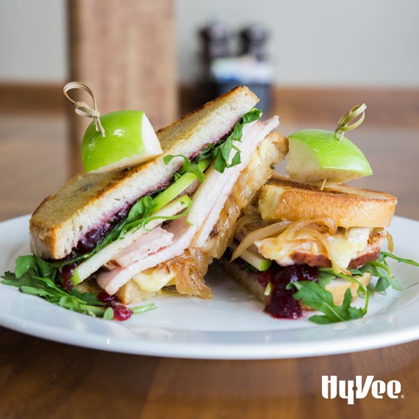 Grilled sandwiches filled with caramelized onions, cranberry sauce, arugula, green apples, and sliced turkey