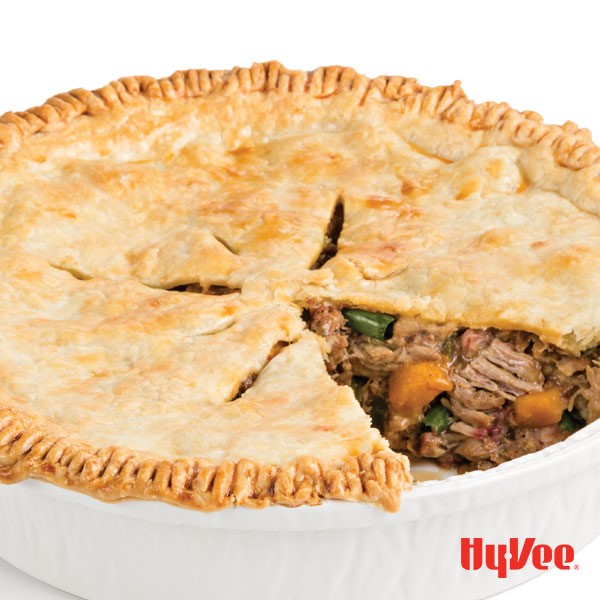 Pulled pork pot pie in a round casserole dish with a slice cut out