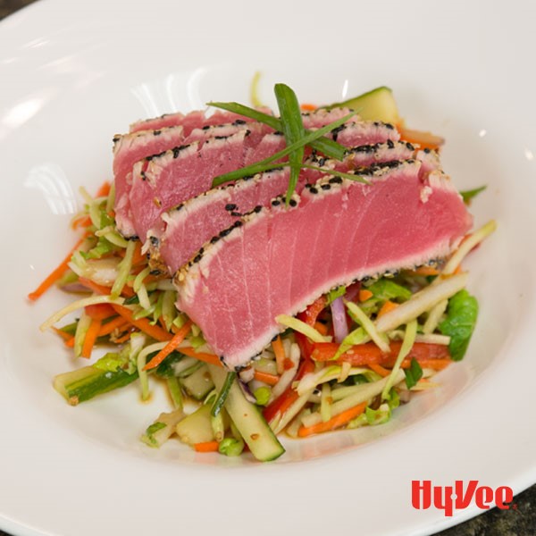 Asian slaw topped with sesame encrusted tuna steaks, served in a bowl