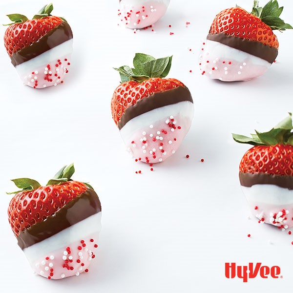 Strawberries dipped in milk, white, and pink-tinted chocolate to form stripes