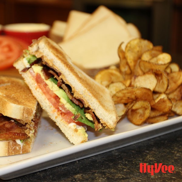 BLT with a side of chips served on a white plate